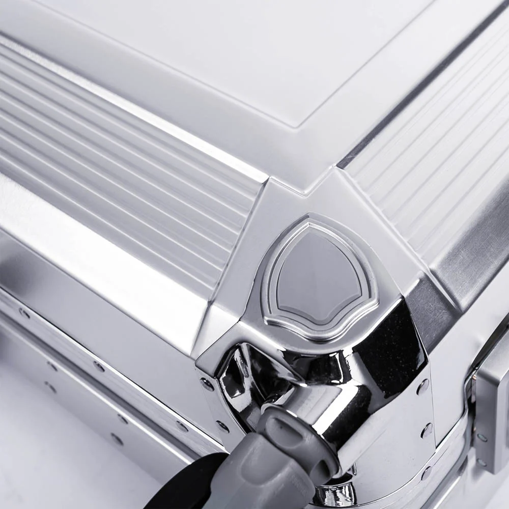 Riveted aluminum frame and hinge detail on metal luggage