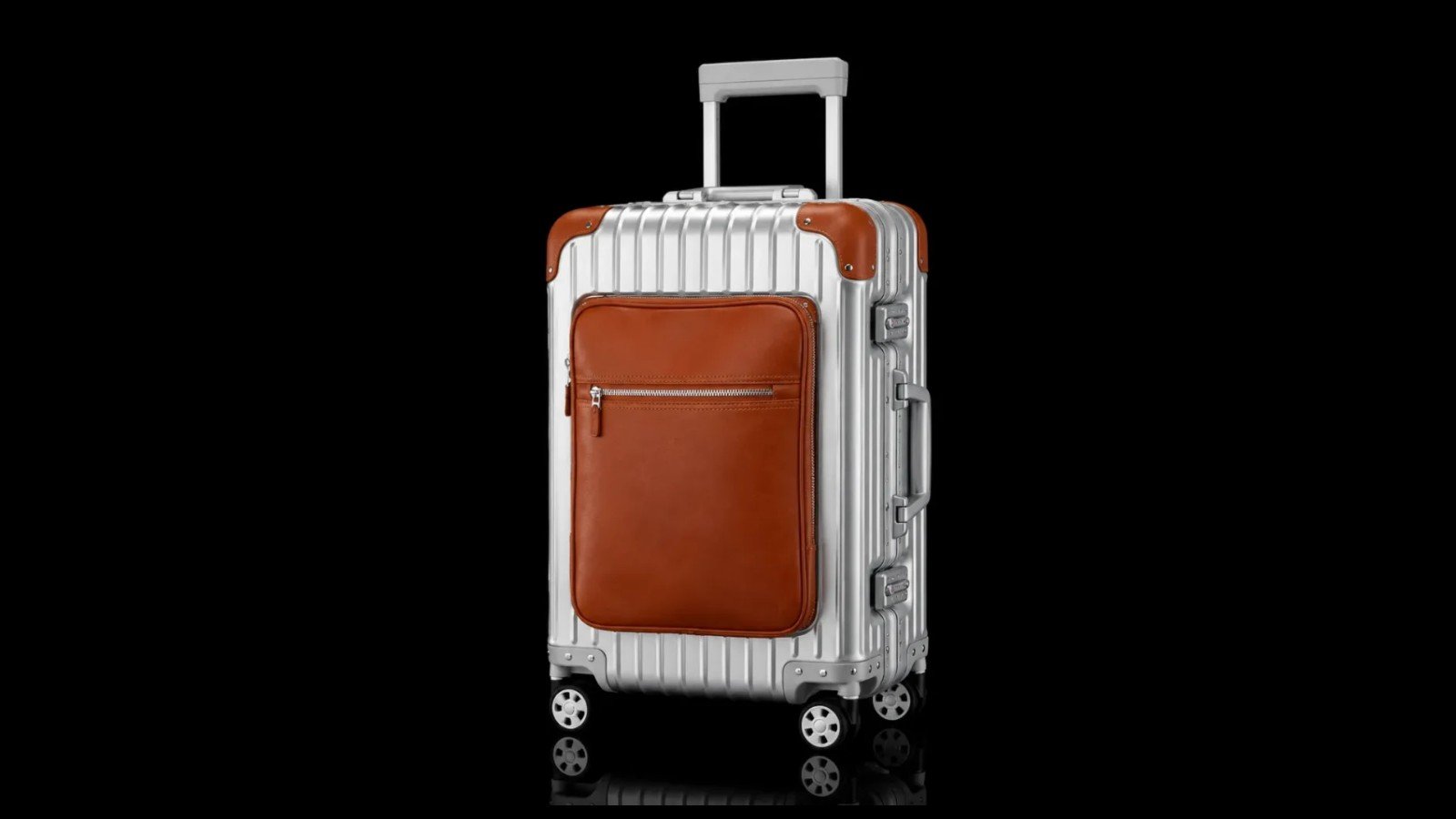 TS-003 metal suitcase with a brown front pocket, shown in full on a black background.